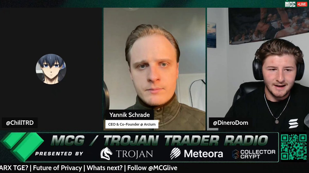 The image shows two men sitting behind computer monitors, likely participating in an online radio show or podcast. The hosts are wearing headphones, suggesting that they might be discussing a topic related to cryptocurrency or financial markets. The background of the image features a green color with white text and logos, which could represent the name of the radio station or the company hosting the show.
