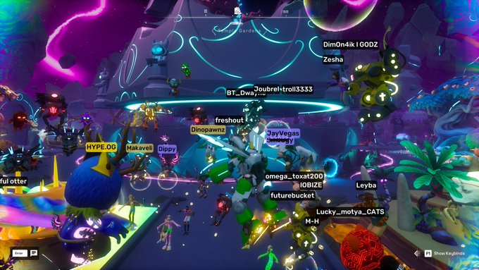 A screenshot from a colorful multiplayer game showing numerous players with various usernames like 'BT_Dw_,' 'Zesha,' and 'JayVegas' gathered in a vibrant, neon-lit environment.