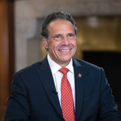 Former New York Governor Andrew Cuomo smiles during a televised interview, captured here as he joins the board of crypto exchange OKX, where he has been advising on legal strategy and U.S. institutional expansion since 2023.