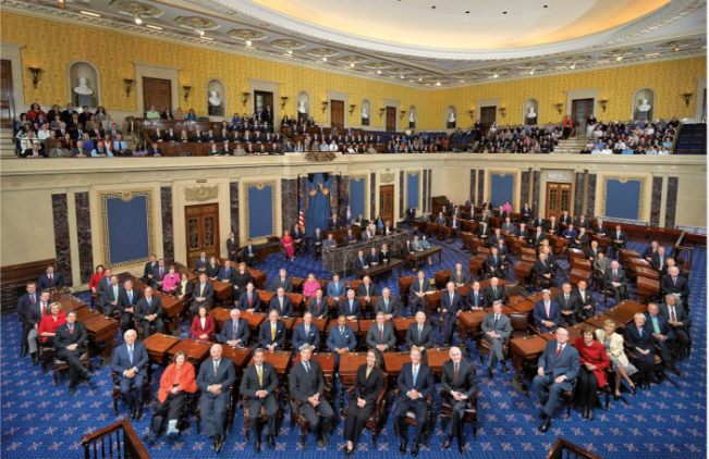 A wide view of the U.S. House of Representatives chamber filled with members seated at their desks during a session.