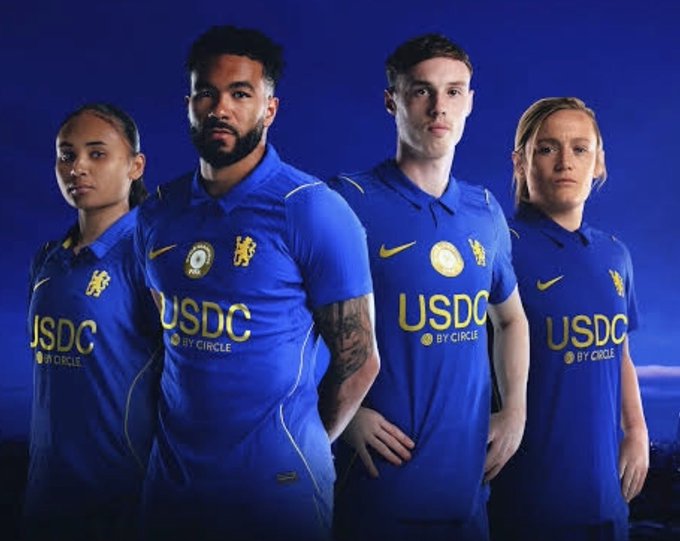 Four football players model blue Chelsea FC jerseys emblazoned with the sponsor "USDC BY CIRCLE," promoting the stablecoin issuer's deal with the club.

The image illustrates the post's critique by showcasing Circle's pricey football sponsorship deal, implying that profits from USDC's T-bill yield scheme are being funneled into marketing tie-ups with Chelsea FC rather than passed to users.