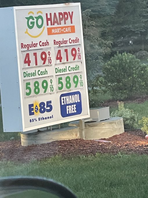 A gas station price sign for 'Go Happy Mart+Cafe' displays Regular at 419 9/10 and Diesel at 589 9/10 for both cash and credit, alongside an 'E85 Ethanol Free' sign.