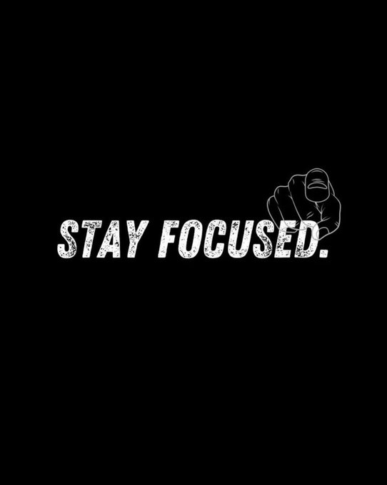 A motivational graphic with a black background featuring the text 'STAY FOCUSED.' next to a black-and-white illustration of a pointing fist.
