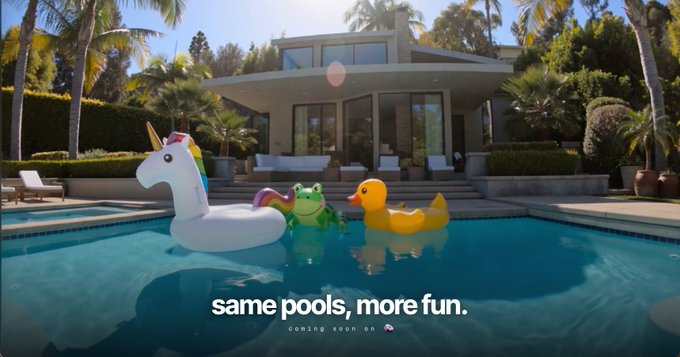 An advertisement showing a luxurious pool with inflatable toys (unicorn, frog, duck) and a modern house in the background. The tagline reads "same pools, more fun. coming soon on" with a logo at the bottom.