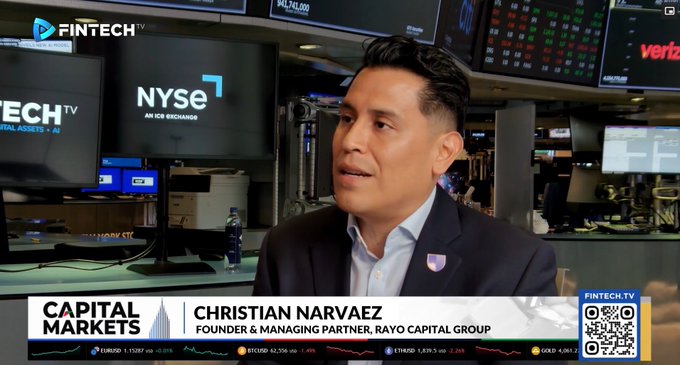 Christian Narvaez, Founder & Managing Partner of Rayo Capital Group, appears on Fintech TV's Capital Markets segment at the New York Stock Exchange, with NYSE branding visible behind him and a market ticker displaying prices for EURUSD (1.17037), BTCUSD (62,586), ETHUSD (2,557.32), and GOLD (4,041.2) at the bottom of the screen.