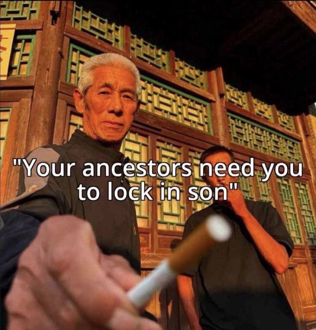The image features two men standing outside of a building, one holding a cigarette while the other has his hand outstretched towards the camera. The text "Your ancestors need you to lock in son" is written above them, which seems to be a quote from an article or blog post. The background includes a wooden structure and a brick wall, giving the scene a rustic feel.