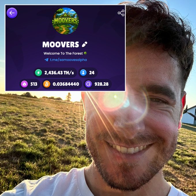 A smiling man takes a selfie outdoors in a grassy field with sunlight, overlaid with a 'MOOVERS' app interface showing 'Welcome To The Forest', 2,436.43 TH/s hash rate, 24 users, 513, 0.03684440, and 928.28 metrics.