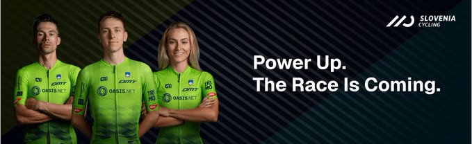 The image features three people wearing green jerseys standing next to each other with their arms crossed. The background of the image is black, making them stand out against it. There are no texts or additional objects present in the image.
