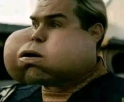 A close-up still from the movie *A Beautiful Mind* shows actor Russell Crowe with an exaggeratedly swollen, lumpy face, likely depicting a medical side effect or allergic reaction. The accompanying "Gm Big day." post humorously pairs with the image, joking about waking up with a puffy, swollen face for an important day.