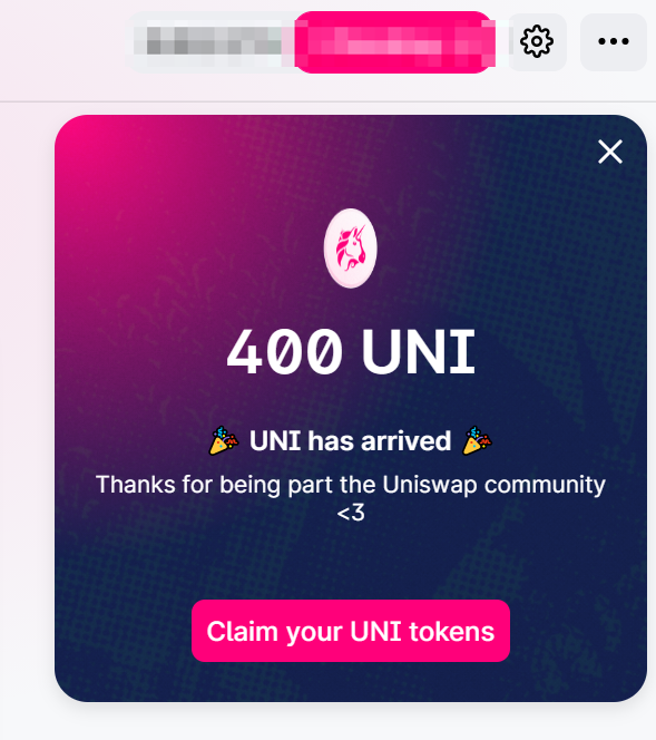 A pop-up notification from Uniswap announcing '400 UNI has arrived' with a 'Claim your UNI tokens' button on a pink and dark gradient background.