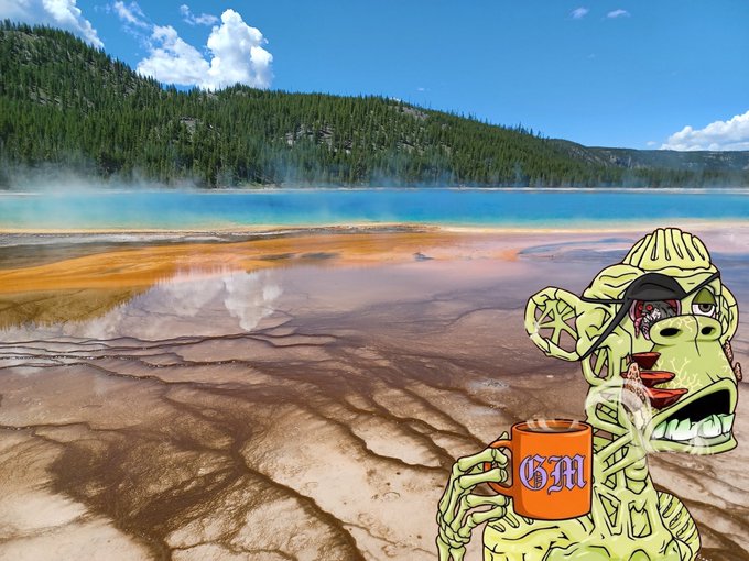 A cartoon skeleton character wearing a backwards cap holds a steaming orange mug labeled 'GM' in front of a scenic landscape of a colorful hot spring and forest.