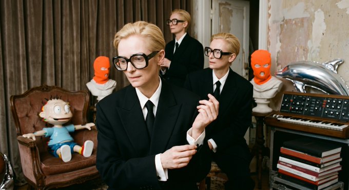 Tilda Swinton appears multiple times as herself and as the character The Ancient One, with figures wearing orange masks and a small doll in a chair.