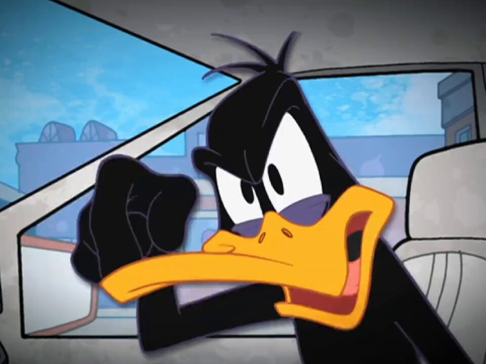 The image features a cartoon character, likely a duck or a frog, sitting inside a car with its head out of the window. The character appears to be making an angry face as if they are upset about something. There is also text present in the image that reads "完蛋了完蛋了，怎么办怎么感觉还没心脏喷血啊", which seems to be a reference or comment about the cartoon character.