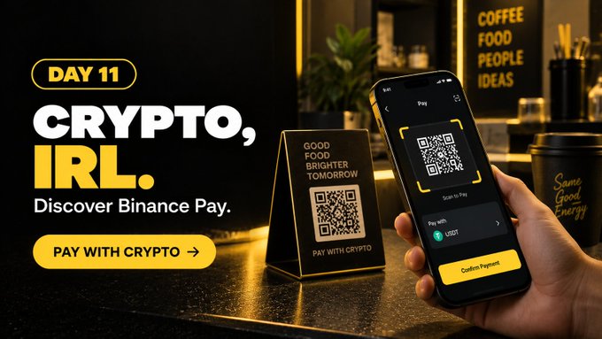 A promotional advertisement titled "DAY 11 CRYPTO, IRL." with the tagline "Discover Binance Pay," showing a hand scanning a QR code to pay with USDT cryptocurrency.