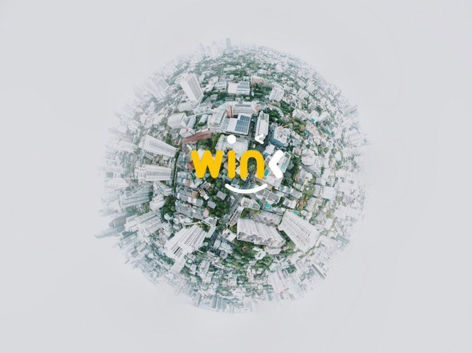 A 360-degree aerial panoramic image of a cityscape rendered as a small planet, featuring the WIX logo overlaid in the center.