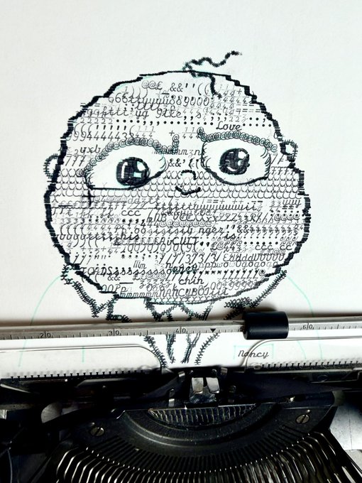 A creative typewriter portrait of a baby's face emerges from densely packed letters and characters, with visible words like "Love" and "nancy," directly tying into the announced collaboration with @yaboynancy. The whimsical artwork showcases an old typewriter resting below the piece, suggesting it's the medium used to craft this character-filled illustration.