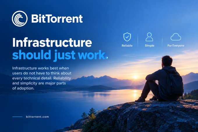 A BitTorrent advertisement featuring a man silhouetted against a sunset lake, with the tagline 'Infrastructure should just work.' and icons highlighting 'Reliable,' 'Simple,' and 'For Everyone.'