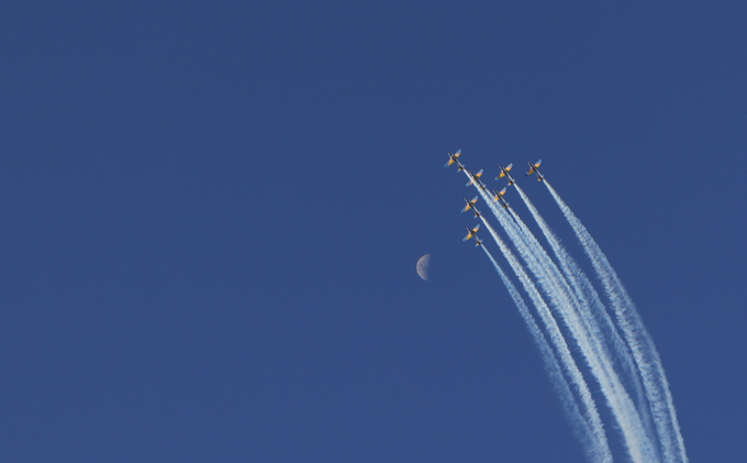 A formation of jets trailing white smoke streaks diagonally across a deep blue sky, with a crescent moon visible to the left of the aircraft. The image evokes a sense of rising momentum and singular opportunity, mirroring the post's urgent call to act before the limited-edition digital art tokens sell out.