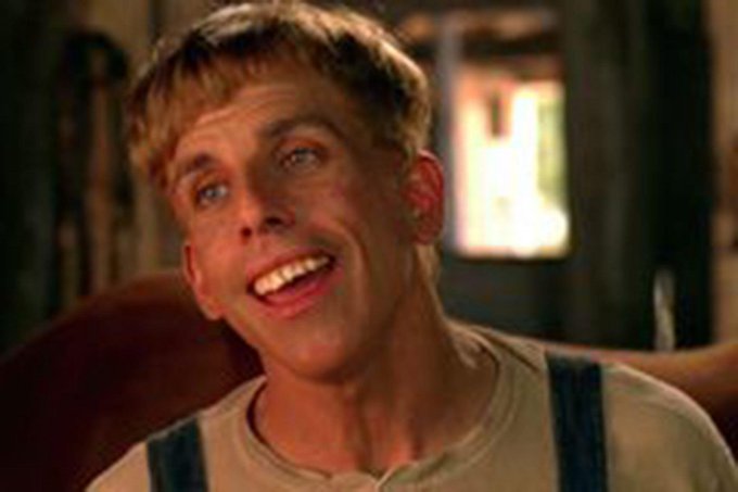 A close-up photograph shows a smiling young man with blonde hair wearing a light-colored shirt with suspenders.