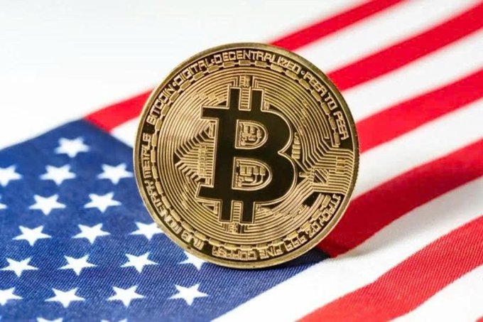 A gold Bitcoin token rests on the American flag, with visible text including "BITCOIN DIGITAL DECENTRALIZED PEER TO PEER" and "FINE COPPER," symbolizing the crypto industry's growing economic impact in the U.S.
