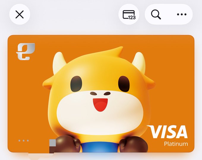 A digital payment card interface shows an orange card featuring a yellow cartoon bull mascot with horns, labeled 'VISA Platinum'.
