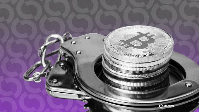 Stacked silver Bitcoin coins resting on metal handcuffs against a purple background with 'decrypt' watermark, symbolizing crypto crime or seizure.