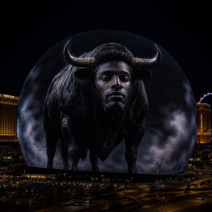 A massive spherical LED screen in Las Vegas displays a striking image of a muscular bull with a man's face, with the Venetian hotel and High Roller observation wheel visible in the background.