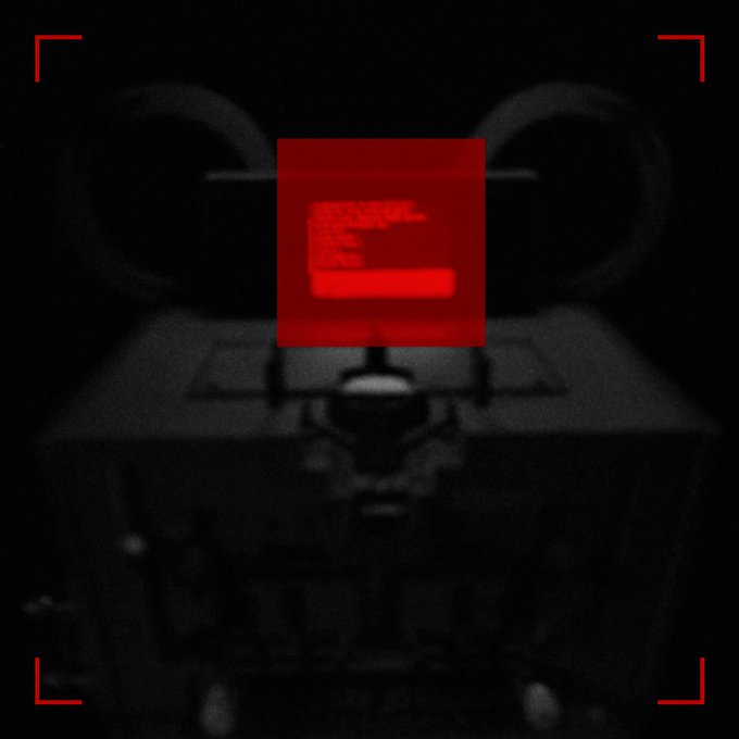 A dark, glitchy image of a face with tubes, featuring a red square overlay with a stylized 'F' logo and red camera framing brackets.