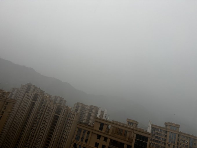 The image shows an aerial view of tall buildings with many windows, suggesting that they are located in a city or urban area. The sky above appears hazy, which could indicate poor weather conditions such as fog or smog. The caption reads "according to what I've heard, this wave of JU coin seems like it hasn'nt ended yet But as long as it's a market, there will always come a time when it does end~". This statement is likely referring to the ongoing popularity and value of JU coins in the market. The image could be interpreted as an advertisement for JU coins or a commentary on their longevity in the market.