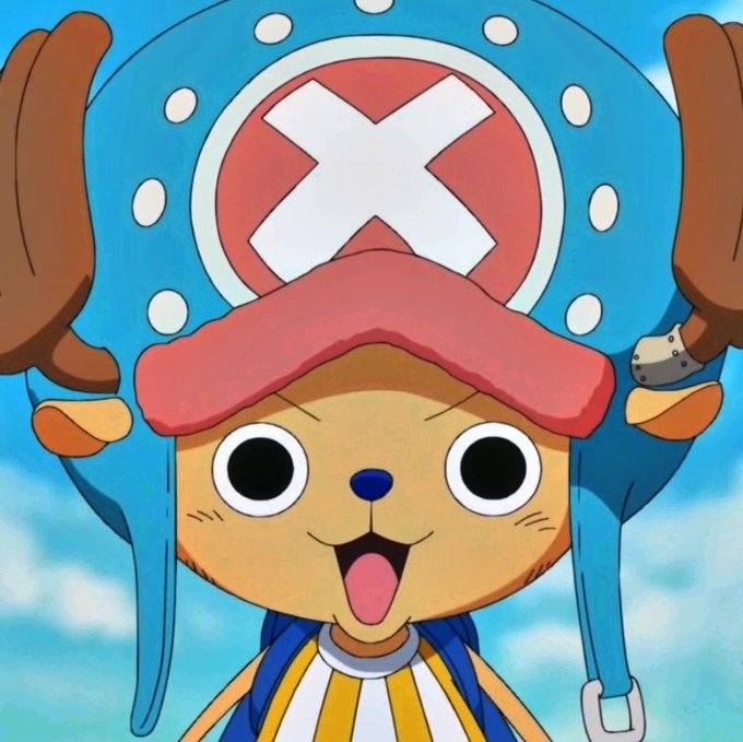 An image of Tony Tony Chopper from the anime One Piece, wearing his signature blue and pink hat with a white cross, with a happy, smiling expression against a blue sky background.