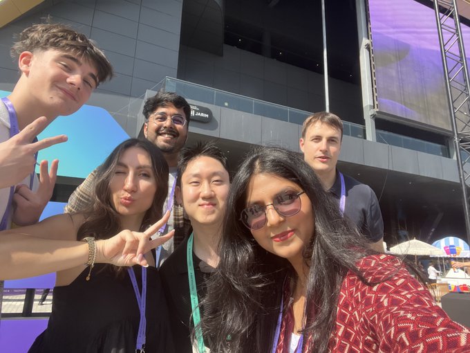 Six colleagues pose for a cheerful selfie outside what appears to be a conference venue, with several flashing peace signs at the camera. The "TREPA" name visible on the lanyards worn by the group connects them to the Trepa founding team mentioned in the caption, likely taken during a crypto/web3 event where they gathered before the author sunset the onchain prediction-market program on Solana.