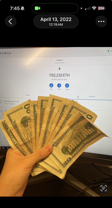 A hand fans out a handful of US $50 bills in front of a computer screen displaying a MetaMask Ledger 1 wallet holding 1,152.232 ETH (approximately $3,082,983.01 USD) as of April 13, 2022—visually capturing the post's "time flies when you're having fun" by contrasting physical cash with a massive crypto portfolio.
