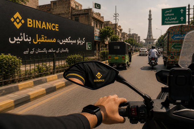 A first-person view from a motorcycle on a street in Lahore, Pakistan (with a sign pointing to Faisalabad) featuring Binance branding and Urdu text advertising crypto trading.