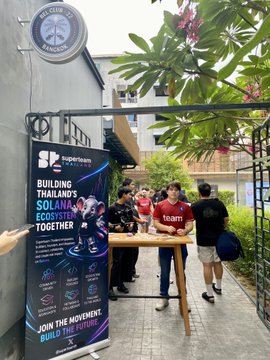 Attendees gather at a Superteam Thailand event booth, where a banner reads "BUILDING THAILAND'S STARTUP ECOSYSTEM TOGETHER" alongside logos for Team1 Avalanche, highlighting the Web3 and startup networking atmosphere referenced in the post.