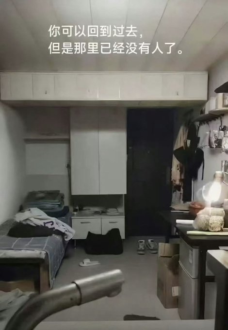 A dimly lit, small bedroom with a bed, white cabinets, and scattered belongings, overlaid with Chinese text that translates to 'You can go back to the past, but there is no one there anymore.'