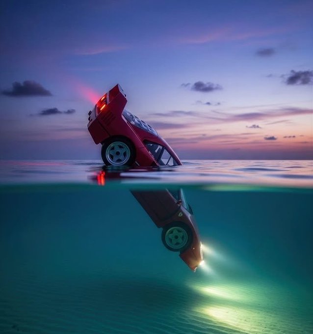 A red car sits tilted at the edge of water at sunset, with its submerged reflection revealing headlights beaming underwater—mirroring the post's "goodnight/good morning" theme. The split above/below view visually echoes the privacy paradox in Web3: transparent surface activity concealing encrypted, secured depths, much like Fhenix's encrypted layer.