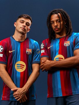 Two FC Barcelona players model the club's new striped home jersey featuring the Spotify sponsor logo across the chest, with the word "AURA" suggesting the kit's bold, confident energy captured in their poised stances.