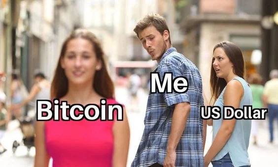 The classic 'Distracted Boyfriend' meme captioned to depict the man ('Me') looking longingly at Bitcoin while his girlfriend ('US Dollar') glares in disapproval.