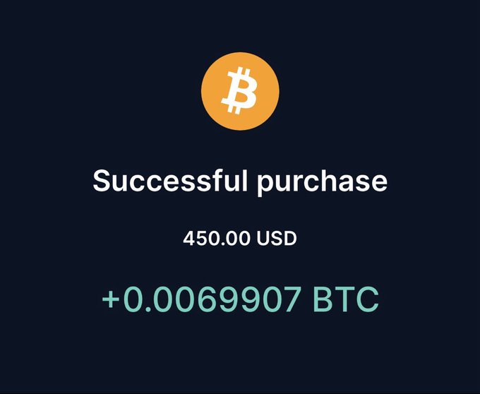 A digital screen displays a successful Bitcoin purchase confirmation of 450.00 USD for +0.0069907 BTC.