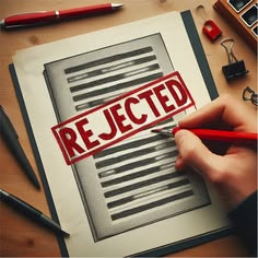 A hand uses a red marker to stamp the word 'REJECTED' in large red letters across a document on a clipboard, with other office supplies like pens and a binder clip visible nearby.