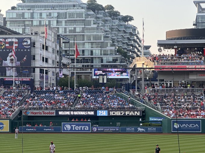 A baseball game in progress at Nationals Park in Washington D.C., showing the stands filled with fans and various advertisements including Harris Teeter, Terra, MGM, and Vanda.