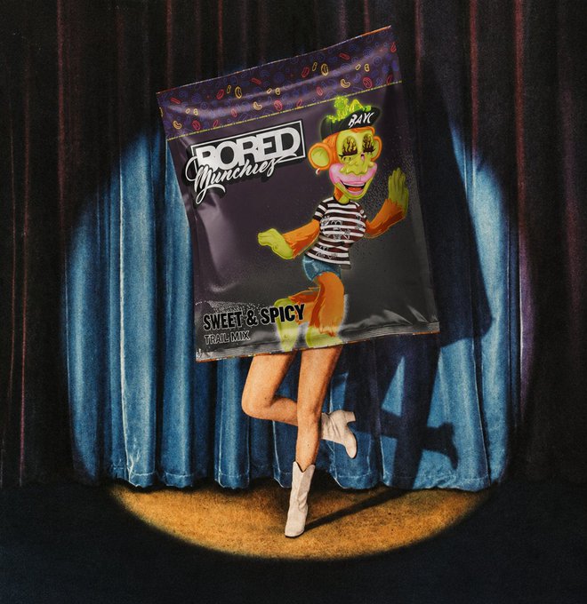 A surreal photo composite showing a bag of 'BORED Munchies Sweet & Spicy Trail Mix' with a vintage clown emerging from the packaging, set against a blue curtain backdrop.