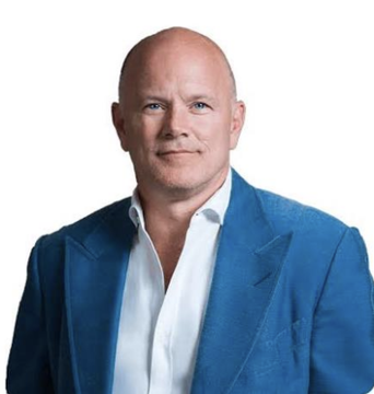 A professional headshot shows a bald man wearing a blue blazer over a white collared shirt, smiling warmly at the camera. The image accompanies the announcement that Mike Novogratz, CEO of Galaxy Digital, expects the CLARITY Act to pass before the August recess.