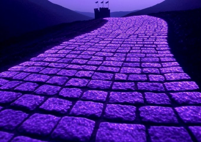 A purple glowing cobblestone path leads toward a distant castle with flags, symbolizing Ripple's journey toward regulatory clarity in Washington, D.C. as Congress works on the Clarity Act for digital assets. The illuminated road visually represents the "path" to transparent rules of the road for the crypto industry.