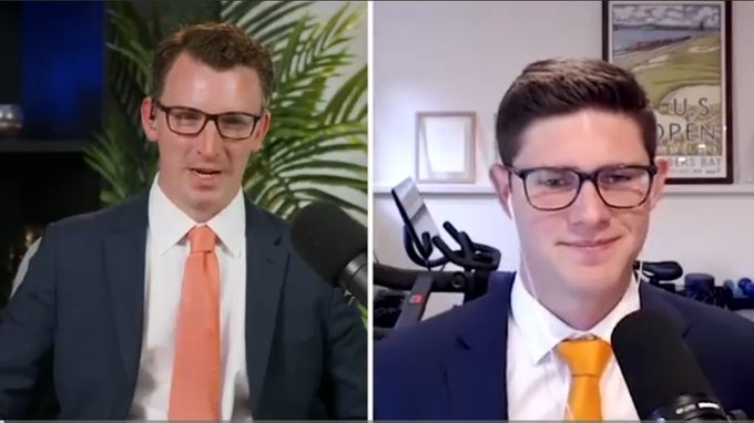 Two men in suits with orange/yellow ties wearing glasses sit in a podcast/video call setup with microphones visible.
