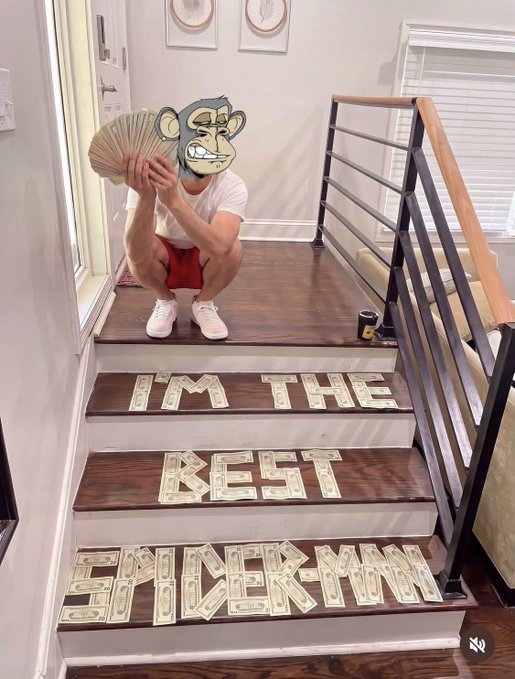 A person wearing a Bored Ape mask crouches on a staircase covered in cash spelling 'I'M THE BEST SHACKMAN', holding a fan of dollar bills.