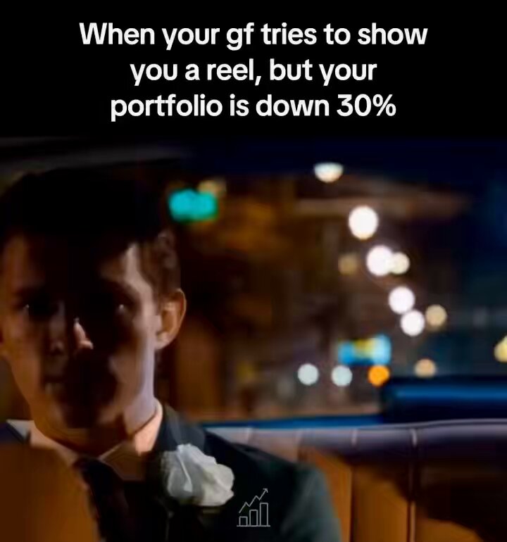 The image shows a man with white flowers tucked into his lapel wearing a suit and tie. A text overlay appears below it saying "BTC - 18% this week. SOL - 22%. ETH - 22%. But I still gotta smile through dinner like I'm not losing my shit. Can't lose the bag AND the girlfriend in a market like this." It seems to be related to Bitcoin, possibly discussing its performance or market sentiment based on the text.