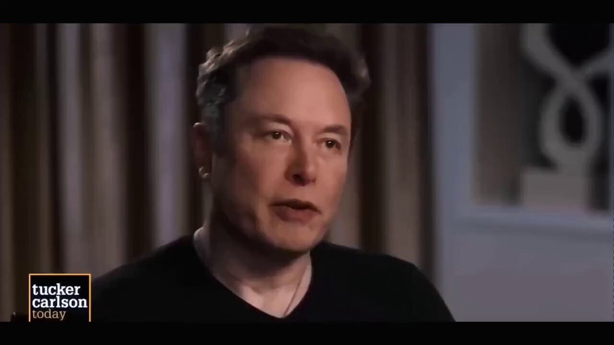 The image displays a close up of an interview with the man who is wearing black color t-shirt and has a serious expression while talking about Bitcoin. The background features a window, indicating that he might be indoors or sitting near a window during his conversation. There are no texts present in the image directly related to the post title.