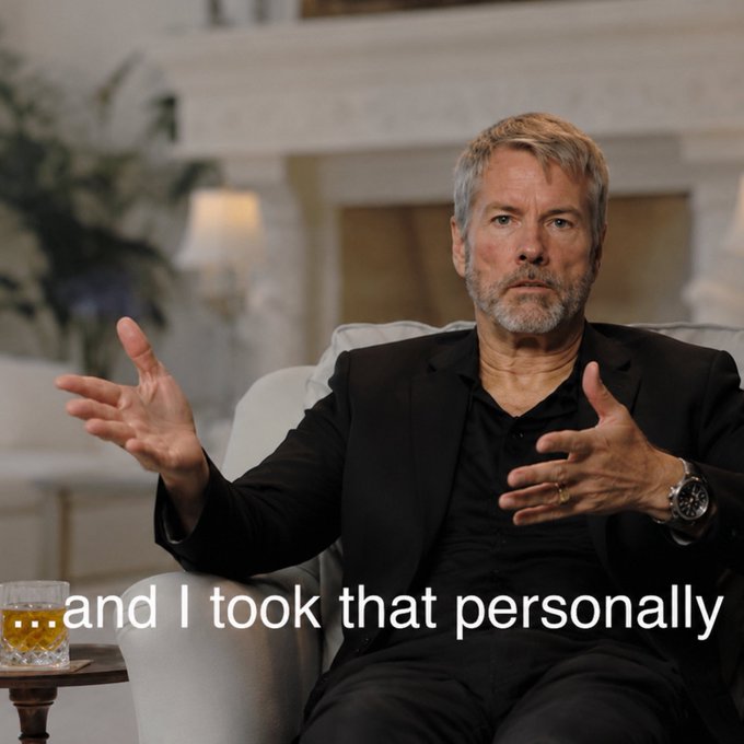 An older man with a beard, wearing a black suit, sits in a chair and gestures with his hands while speaking, with the text "... and I took that personally" overlaid at the bottom.