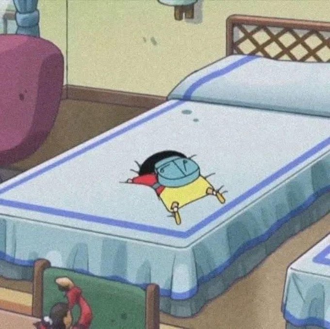 A scene from the anime Crayon Shin-chan showing Shin-chan lying face-down and motionless on a bed in his bedroom.